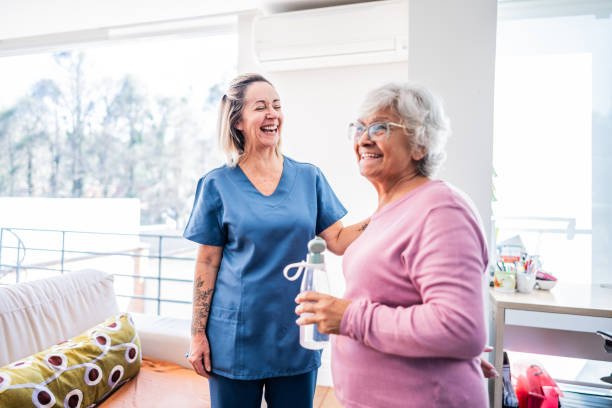 A carer and a resident laughing together at home