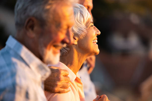 An older couple smiling together in evening light